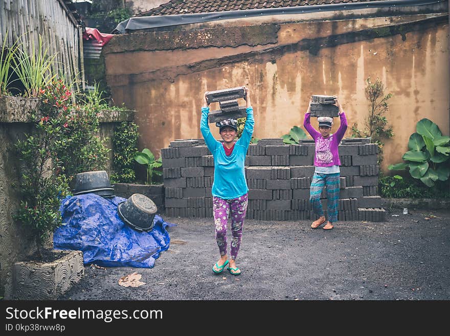 Photography of People Carrying Cinder Blocks