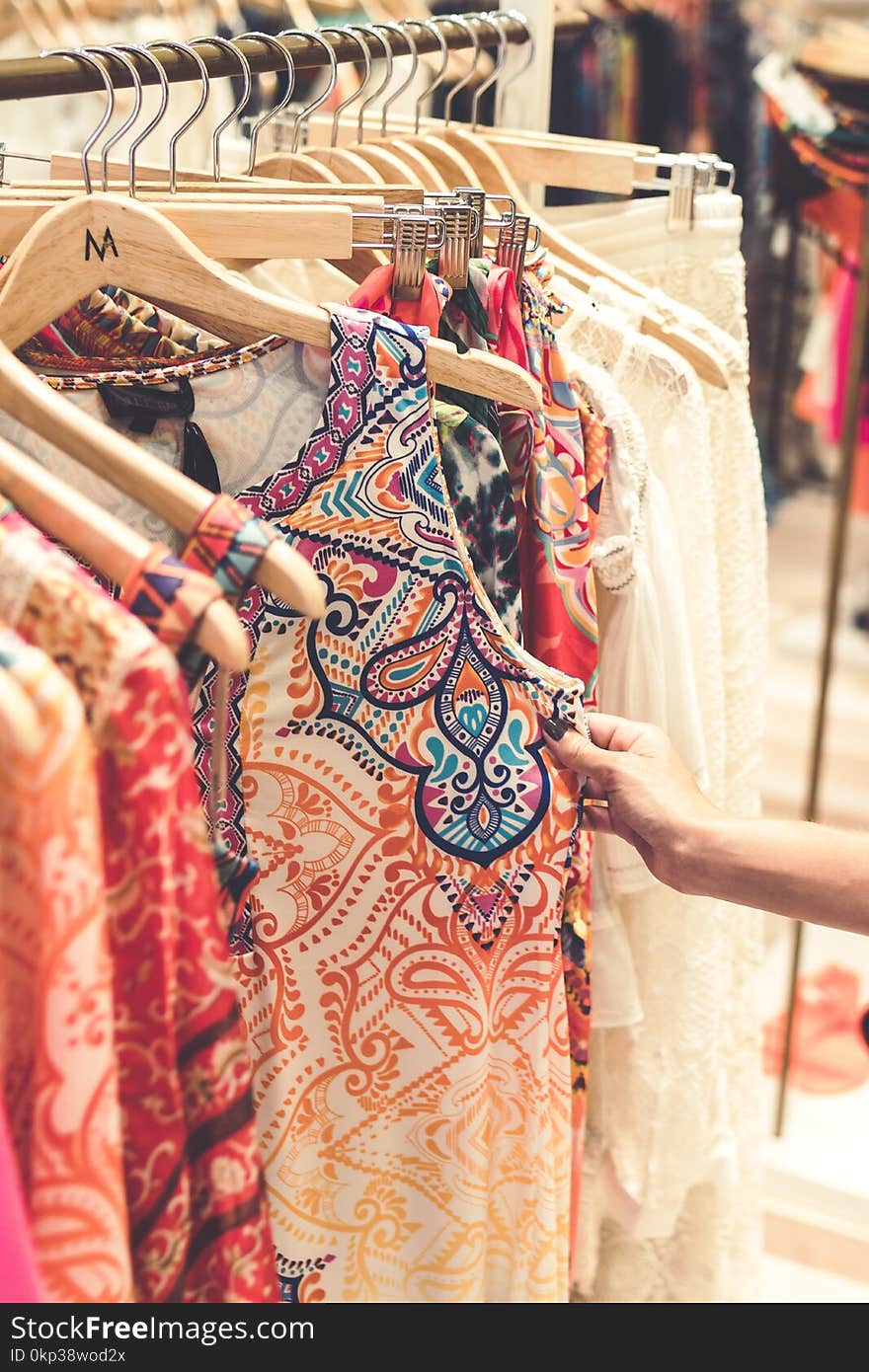 Shallow Focus Photography of Assorted-color Clothes Hanged on Clothes Rack