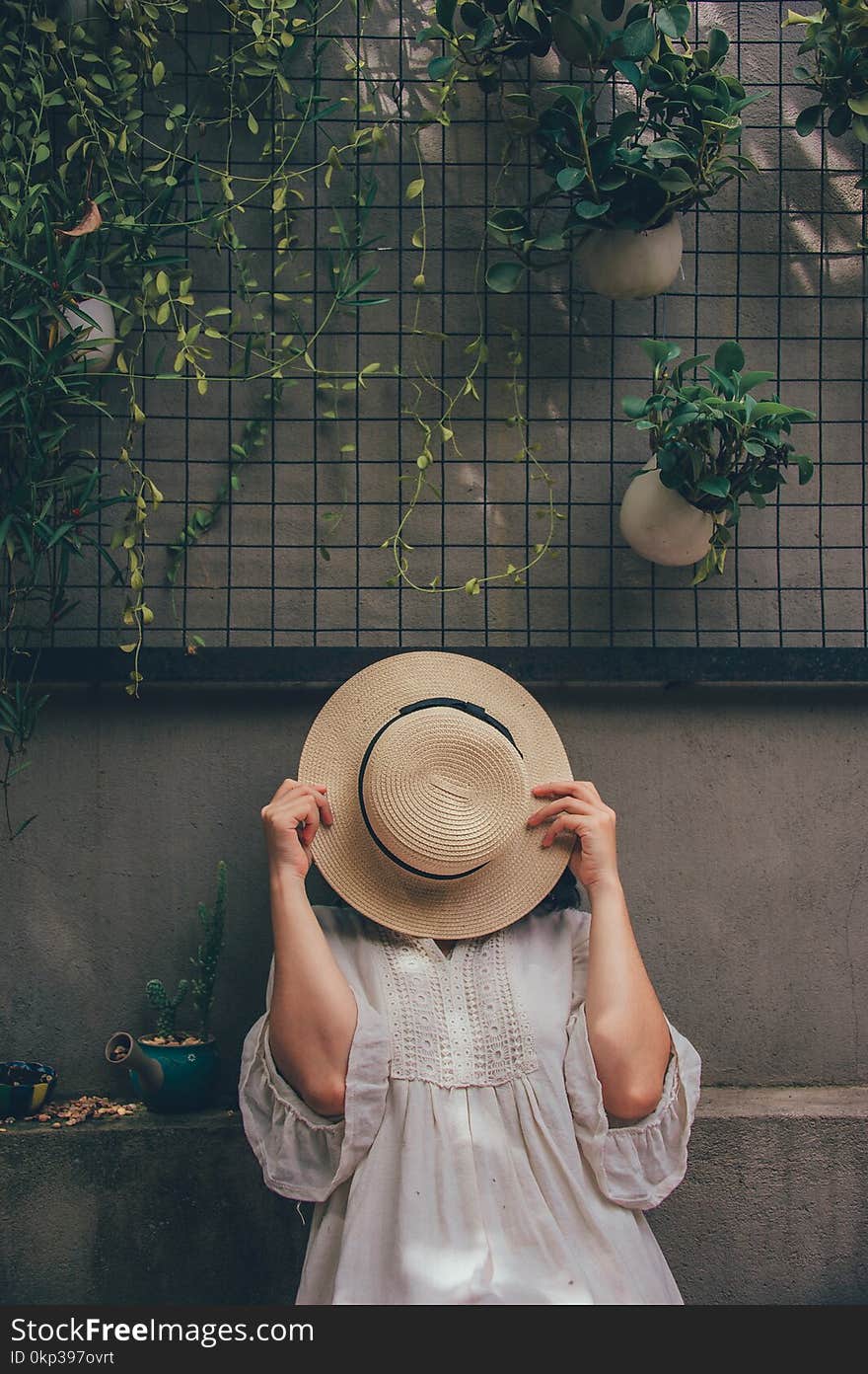 Woman Holding a Brown Hat