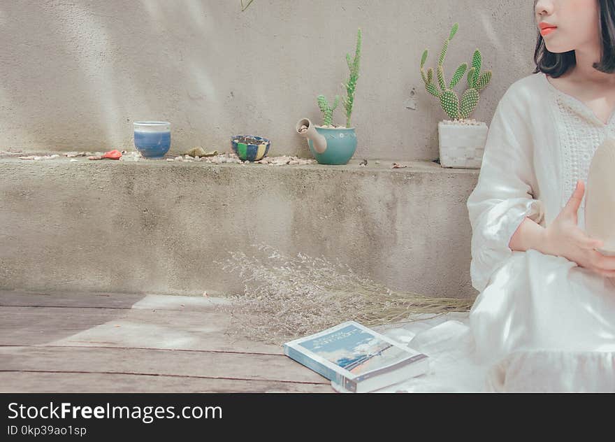 Photography of a Woman Sitting Near Ledge