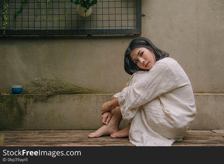 Photo of Woman Sitting Down on Floor