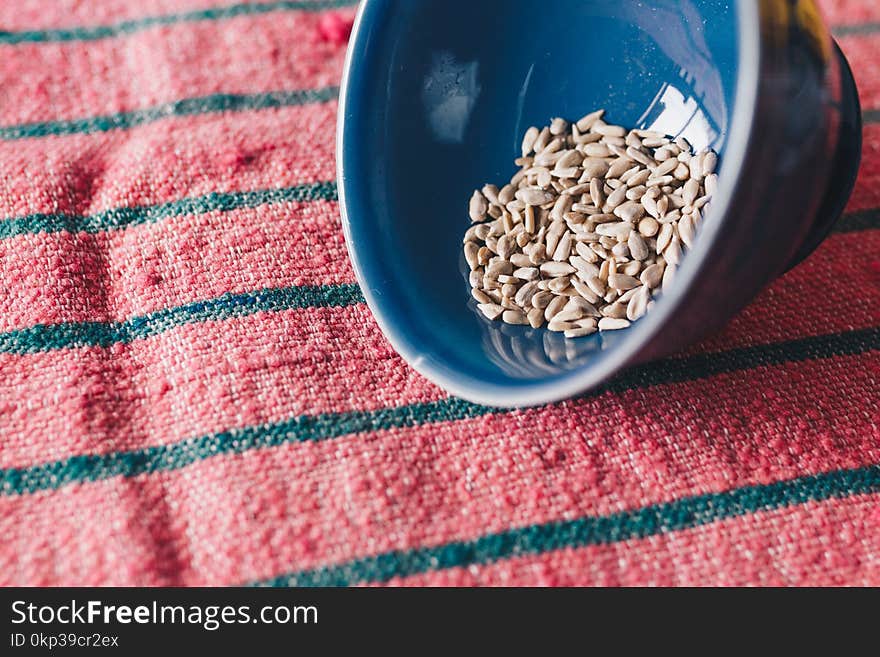 Brown Seeds On Blue Ceramic Bowl