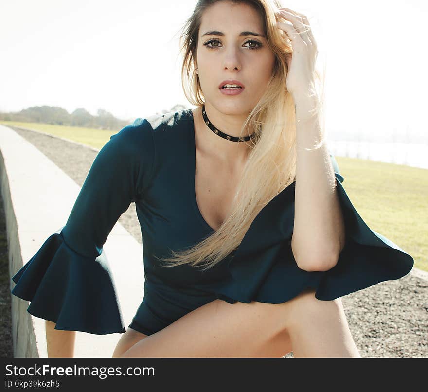 Woman in Black Trumpet-sleeve Shirt on Top of Gray Wall