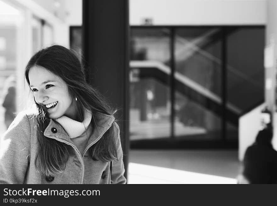 Woman in Gray Jacket Near Black Board