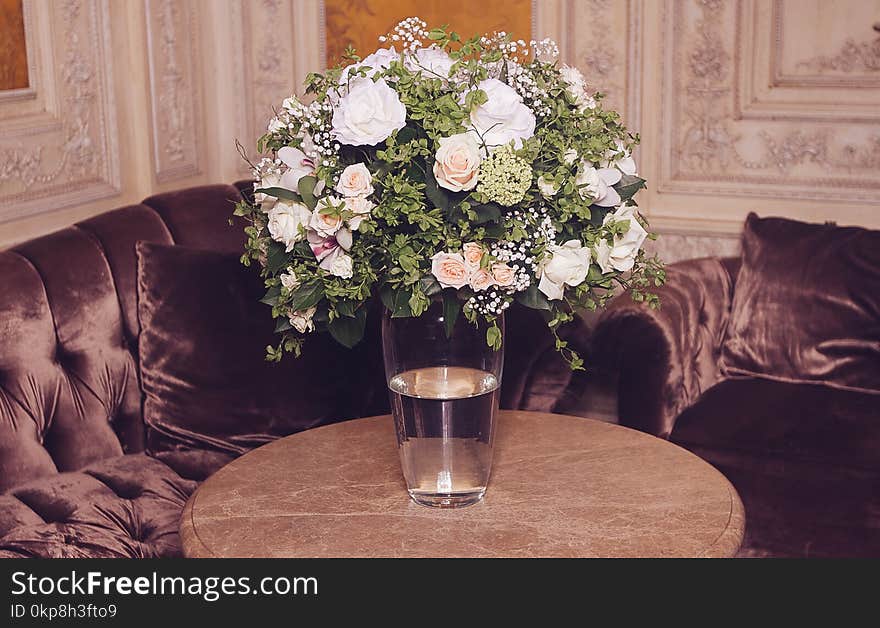 Bouquet of white roses on marble table in interior of the Baroque style