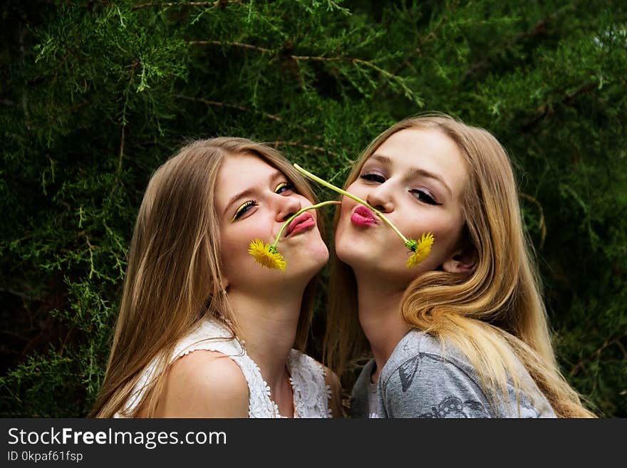 Two cute and beautiful teen girls show grimaces on their faces. Two cute and beautiful teen girls show grimaces on their faces.