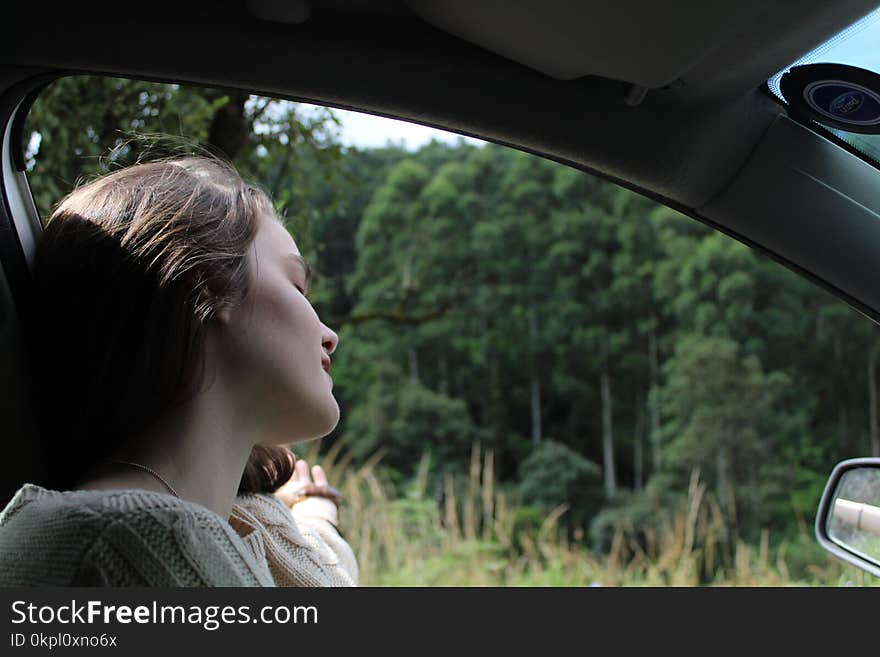 Woman in White Top Inside Vehicle