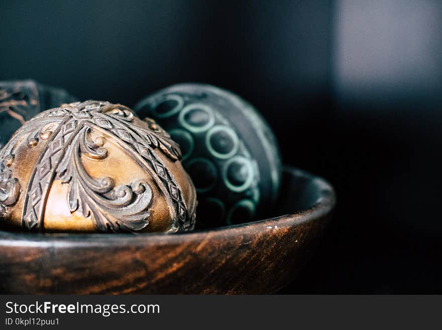 Brown and Two Black Ball in Bowl Photography