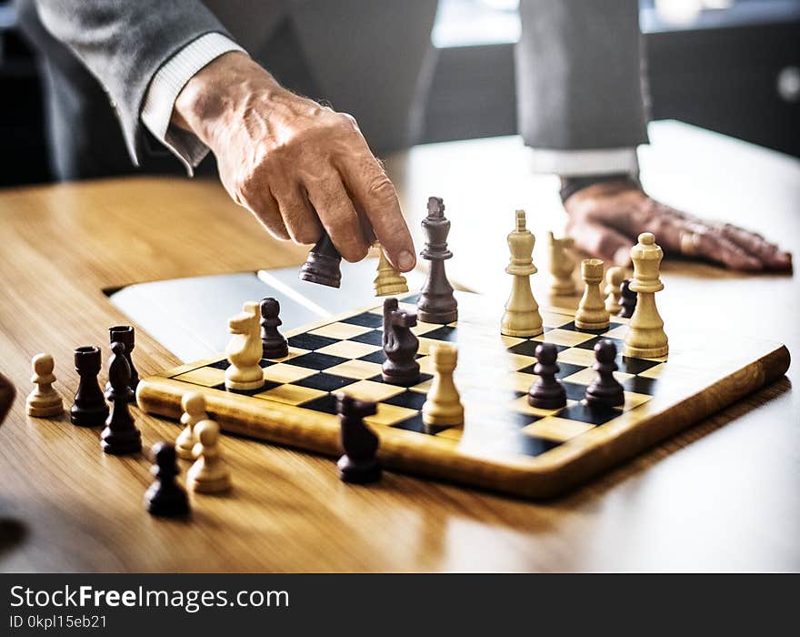 Man in Gray Suit Playing Chess