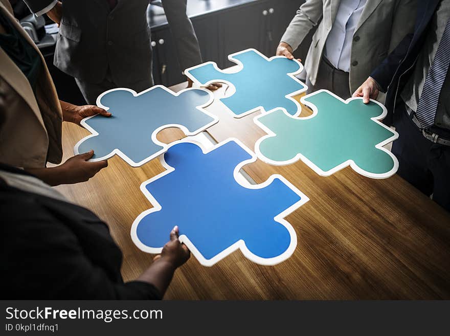 Four People Holding Blue Puzzles