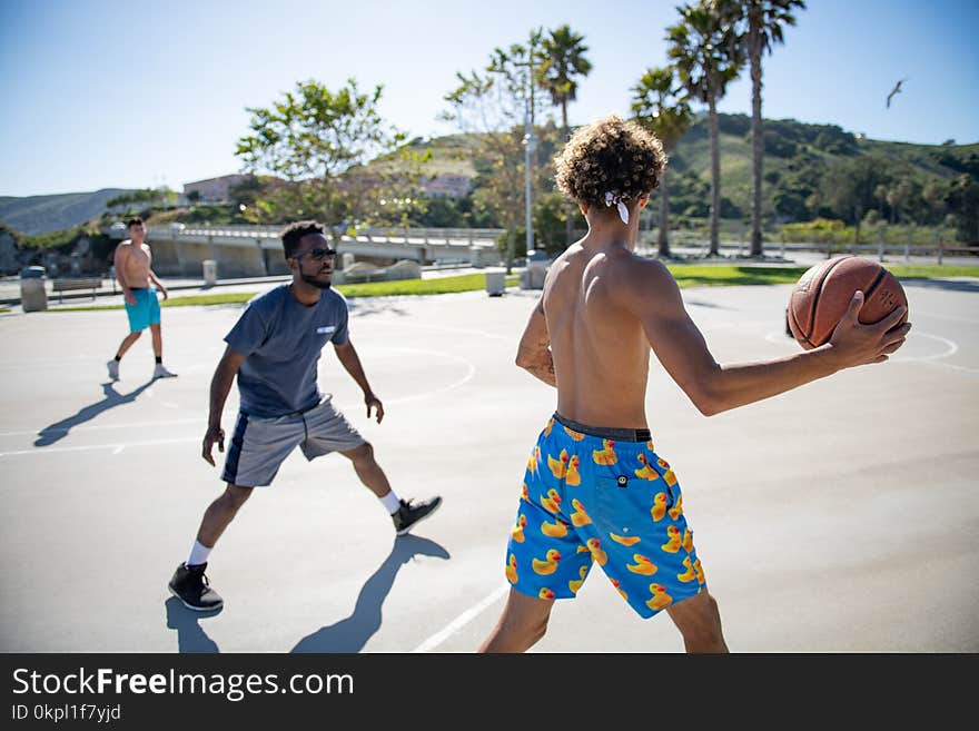 Three Man Playing Basketball