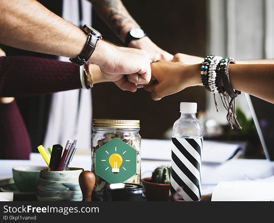 Group of People Putting Fist on Center