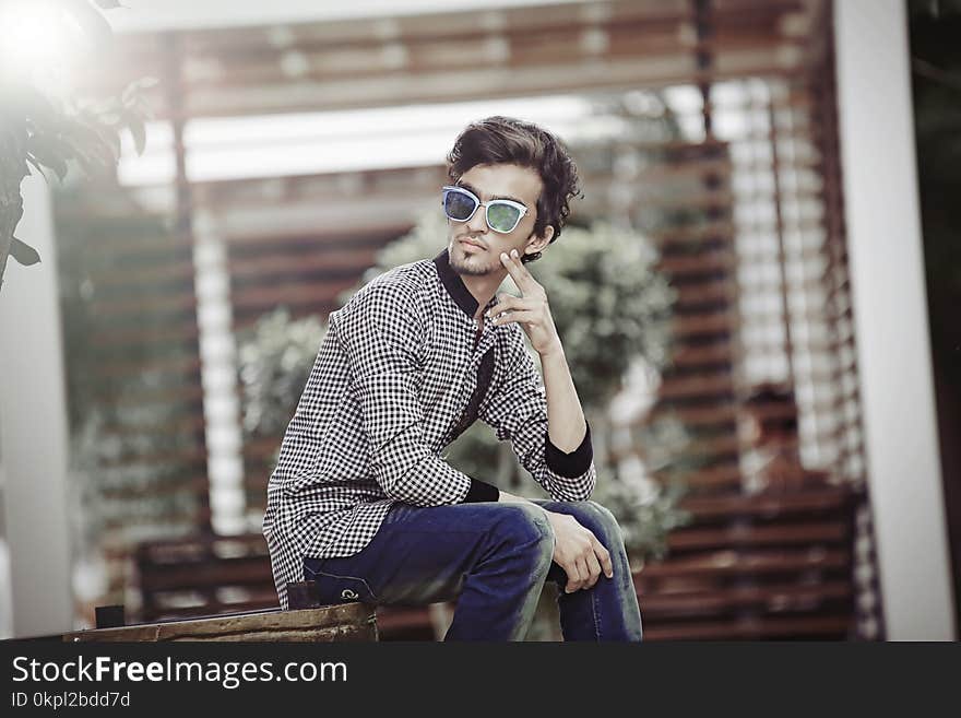 Man Sitting on Brown Wooden Chair