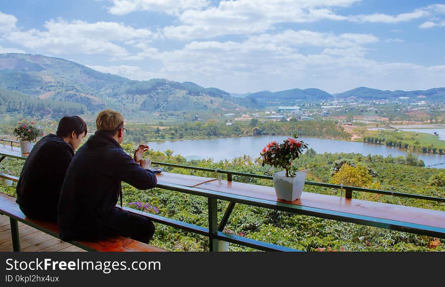 Two Men Sitting On A Bench