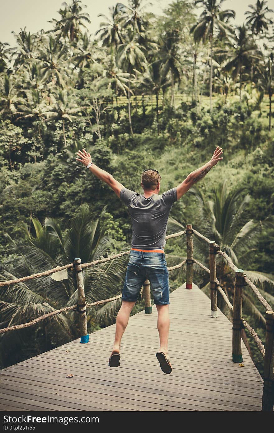 Man Jumping On Wooden Balcony