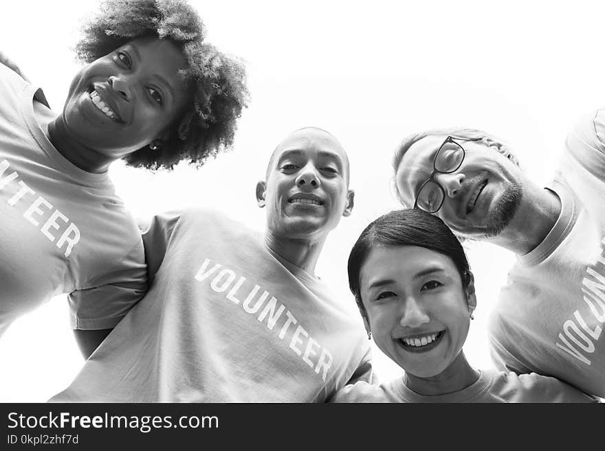 Grayscale Photography of Group of People Wearing Volunteer-printed Shirt