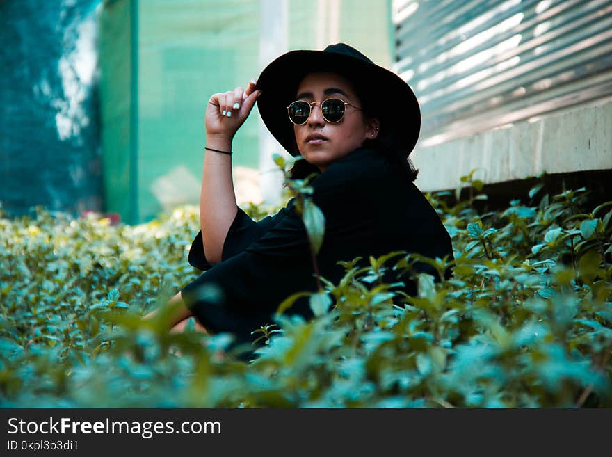 Person In Black Top Wearing Black Bucket Cap