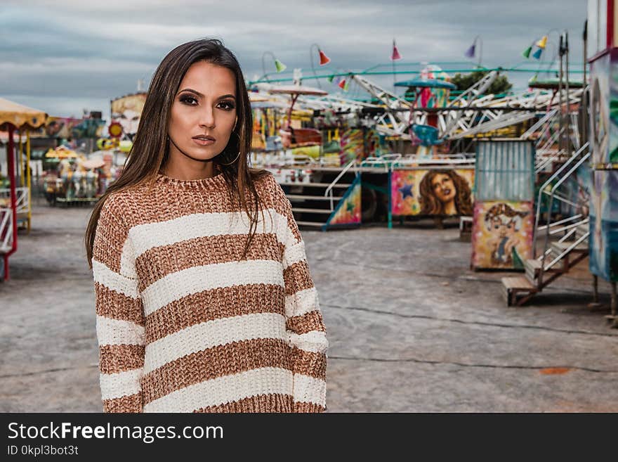 Woman In White And Brown Striped Sweater