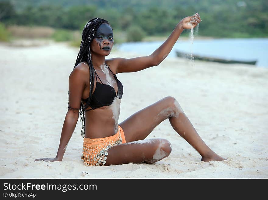 Fashion Photography of Woman Sitting on White Sand White Pouring Sand on Her Hand