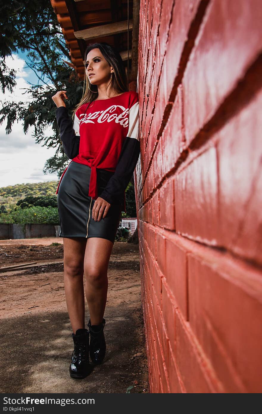 Woman Leaning On Wall Wearing Coca-cola Printed Top