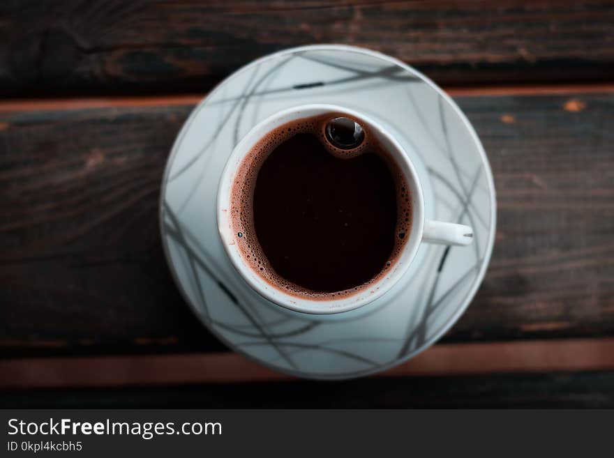 White Cup on Saucer on Brown Wooden Table