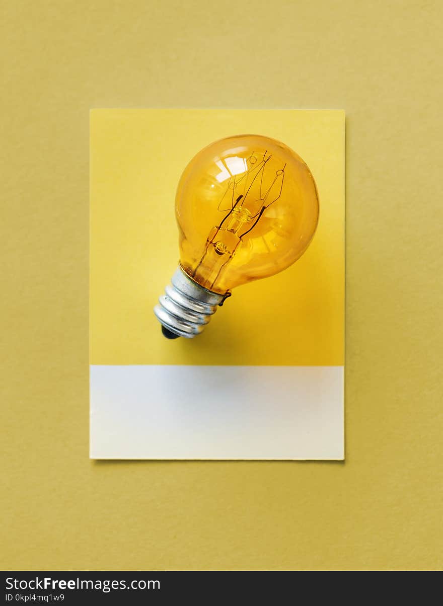 Brown Light Bulb Photo on Yellow Surface