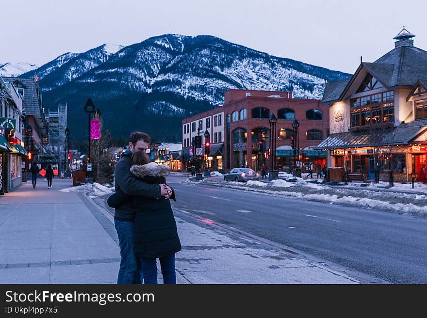 Man Hugging Woman on Street