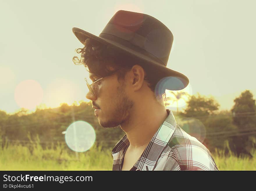 Man Wearing Black Hat and Sunglasses