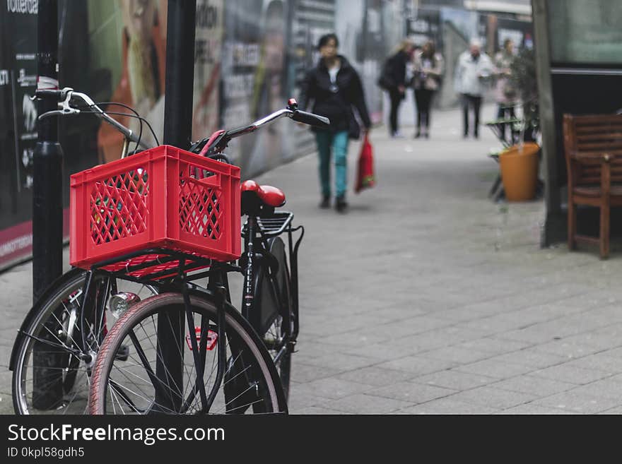 Two Black Bicycles on Post