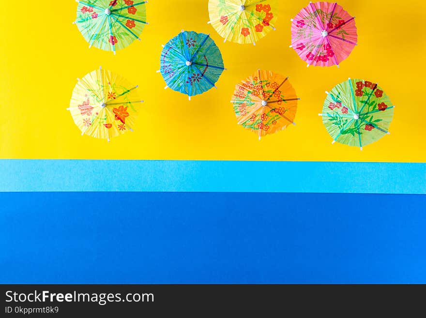 Overhead view on beach with umbrellas and sea with boats. Sea travel and summer vacation minimal concept.