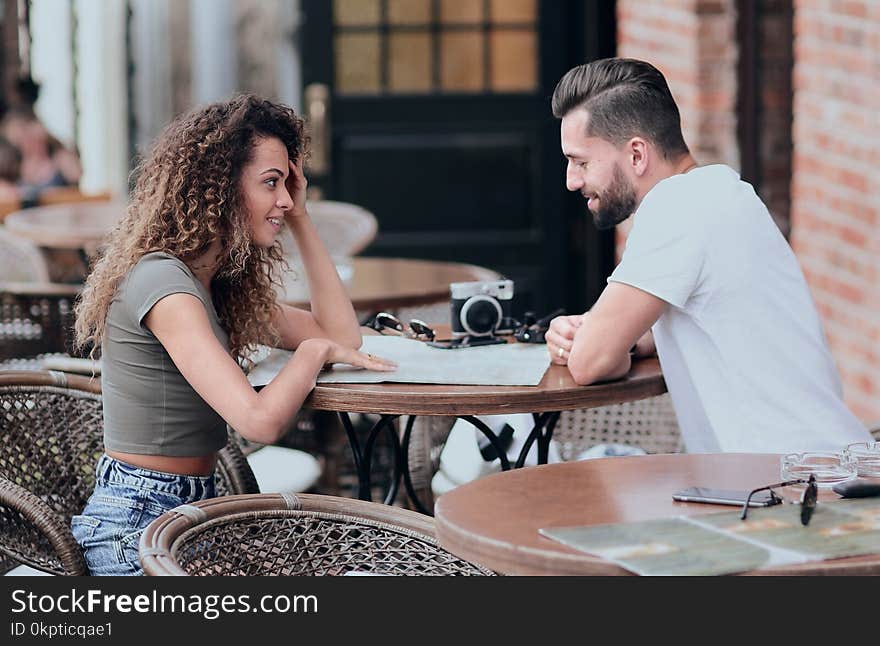 Portrait of a couple sitting down at a cafe while on vacation. Portrait of a couple sitting down at a cafe while on vacation