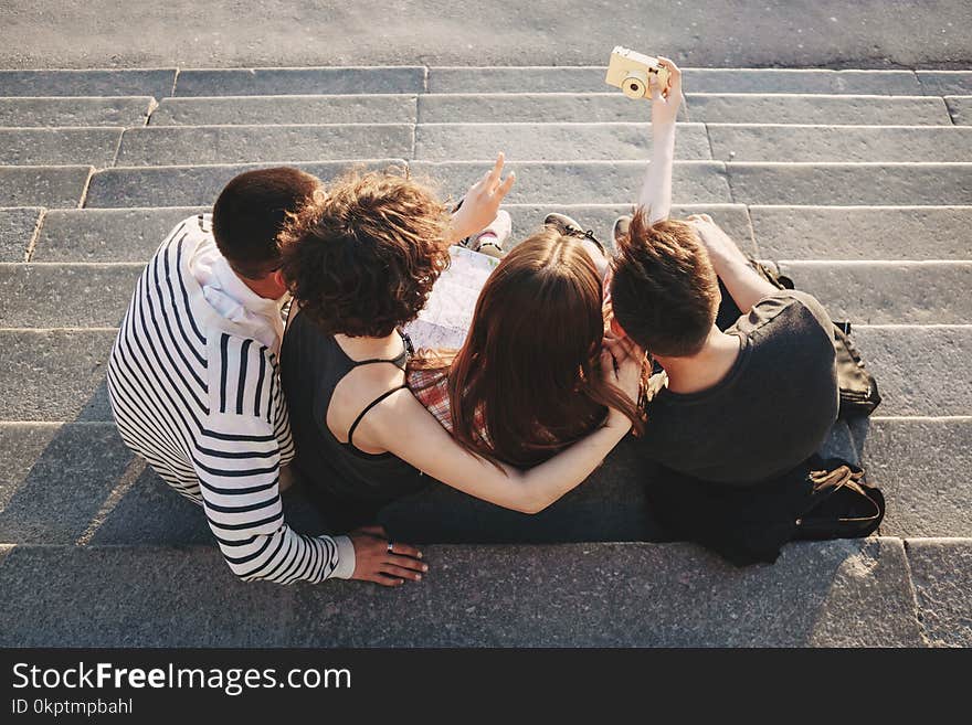 Friendship, togetherness, youth, holidays. Group of friends taking selfie at camera in city