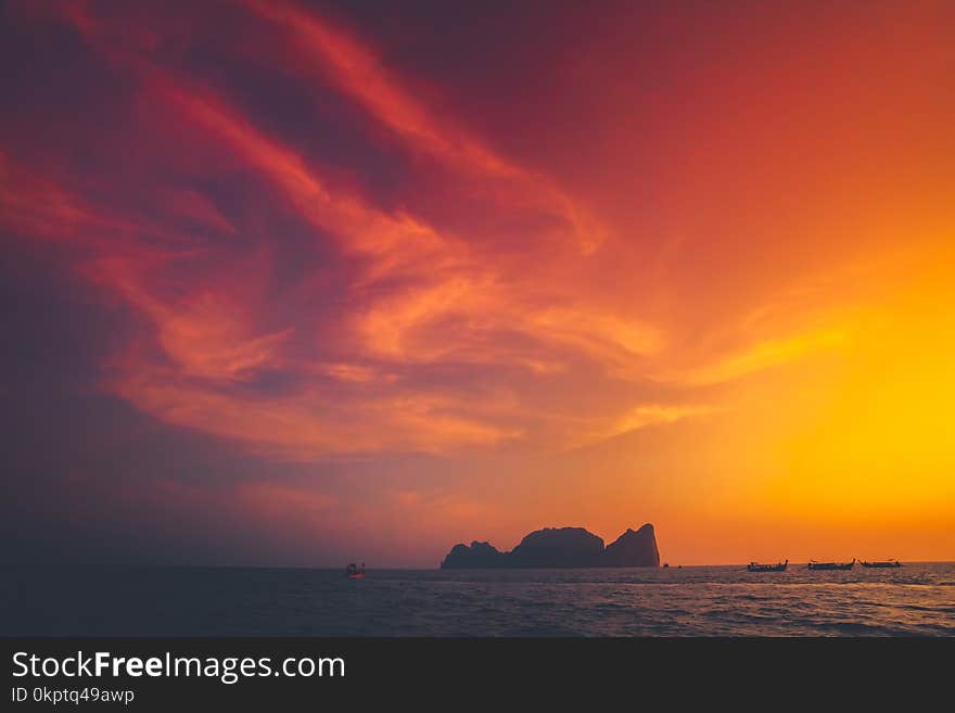 Spectacular sunset over the Indian Ocean next to the exotic Phi Phi Islands in the Kingdom of Thailand. Amazing golden and scarlet color combination. Perfect background. Spectacular sunset over the Indian Ocean next to the exotic Phi Phi Islands in the Kingdom of Thailand. Amazing golden and scarlet color combination. Perfect background.