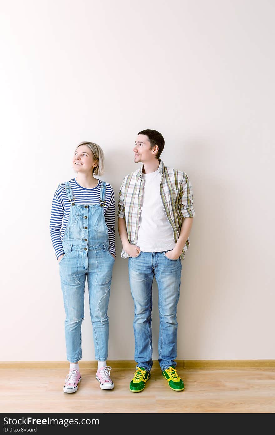 Image of young men and women in new empty apartment. Image of young men and women in new empty apartment