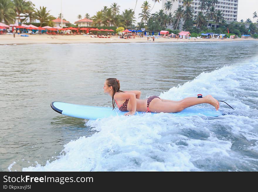Girl surfing on her belly in the ocean. Girl surfing on her belly in the ocean