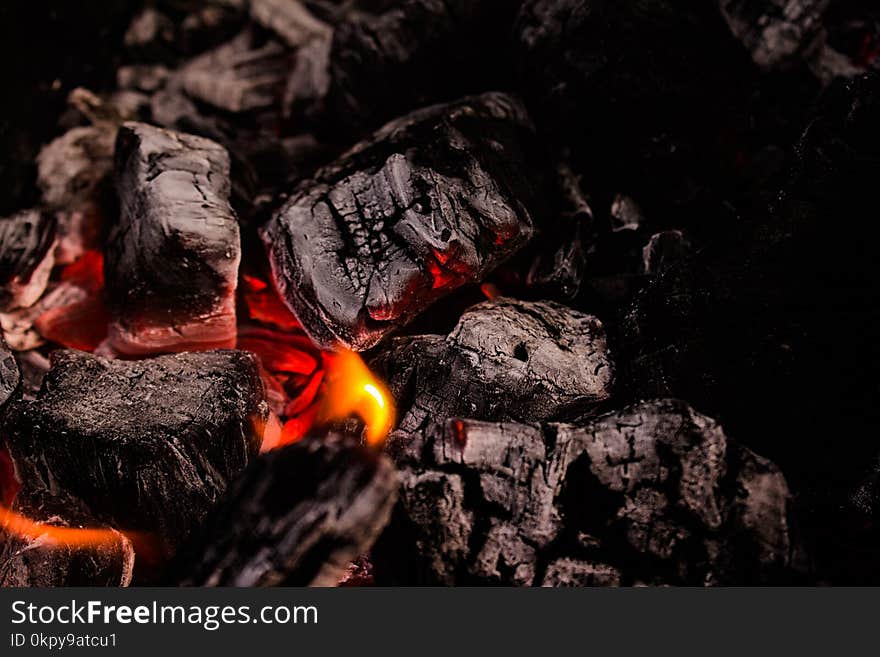 Flaming coals on bbq grill, closeup.