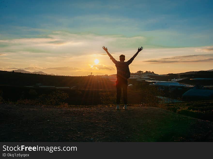 Photography of Man Raising Both Hands