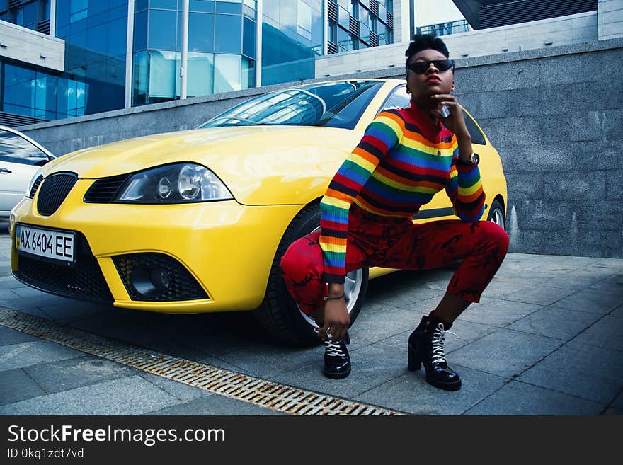 Woman Wearing Red Leggings Beside Yellow Car