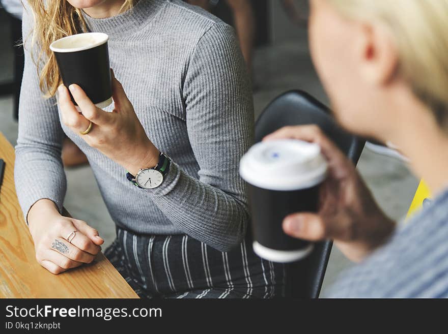 Woman Wearing Gray Sweater Holding Brown Disposable Cup