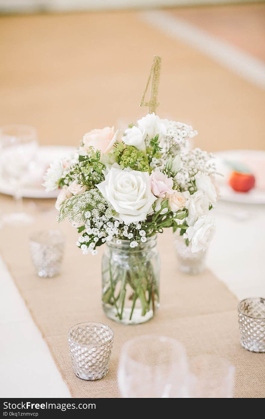 White Flowers on Clear Glass Mason Jar