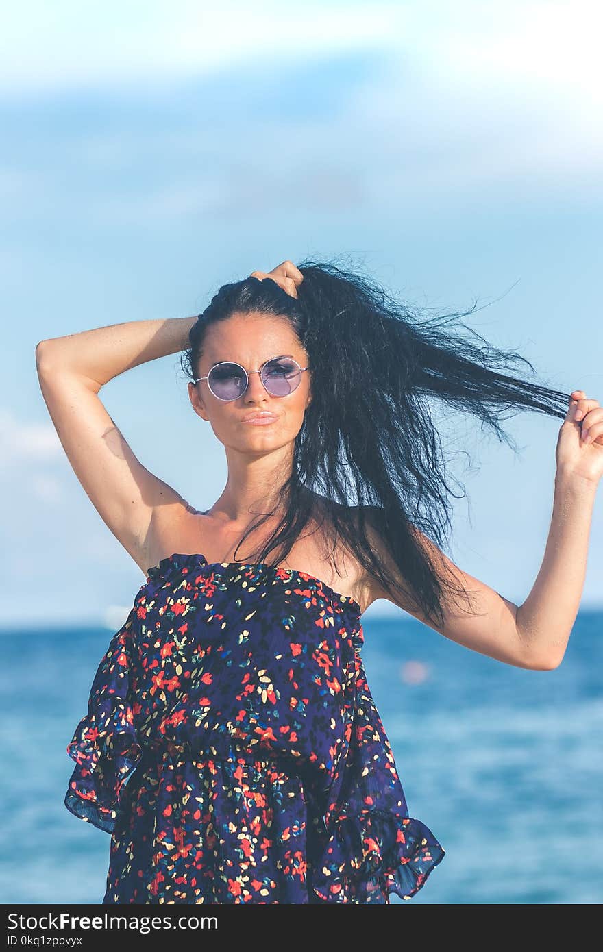 Woman in Blue Dress Standing Near Body of Water