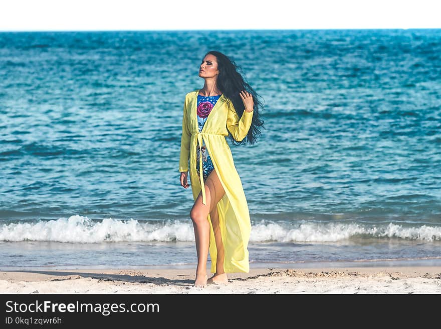 Woman Wearing Blue Monokini Standing on Beach Sand