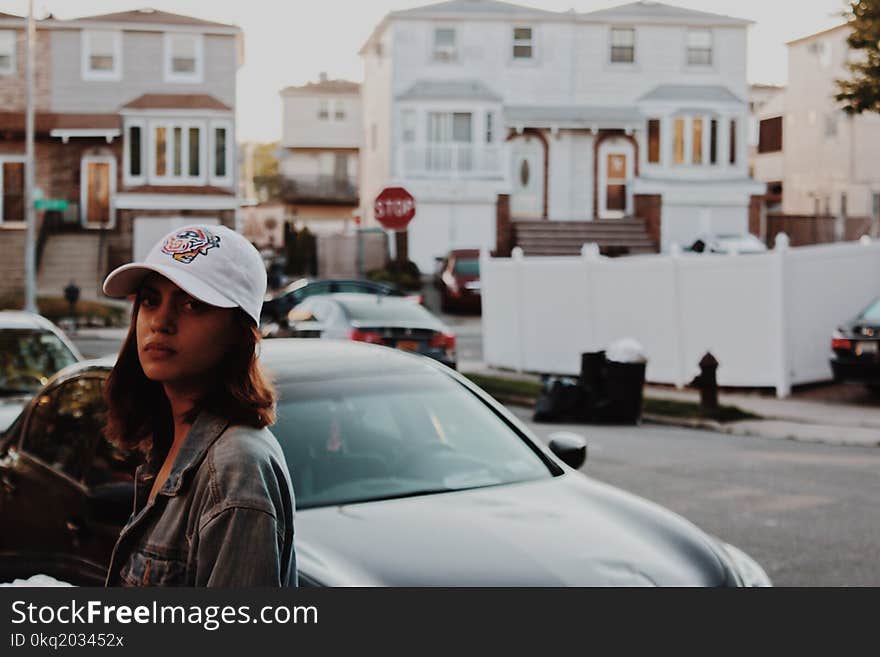 Shallow Focus Photography of Woman in Gray Denim Jacket Standing Near Car