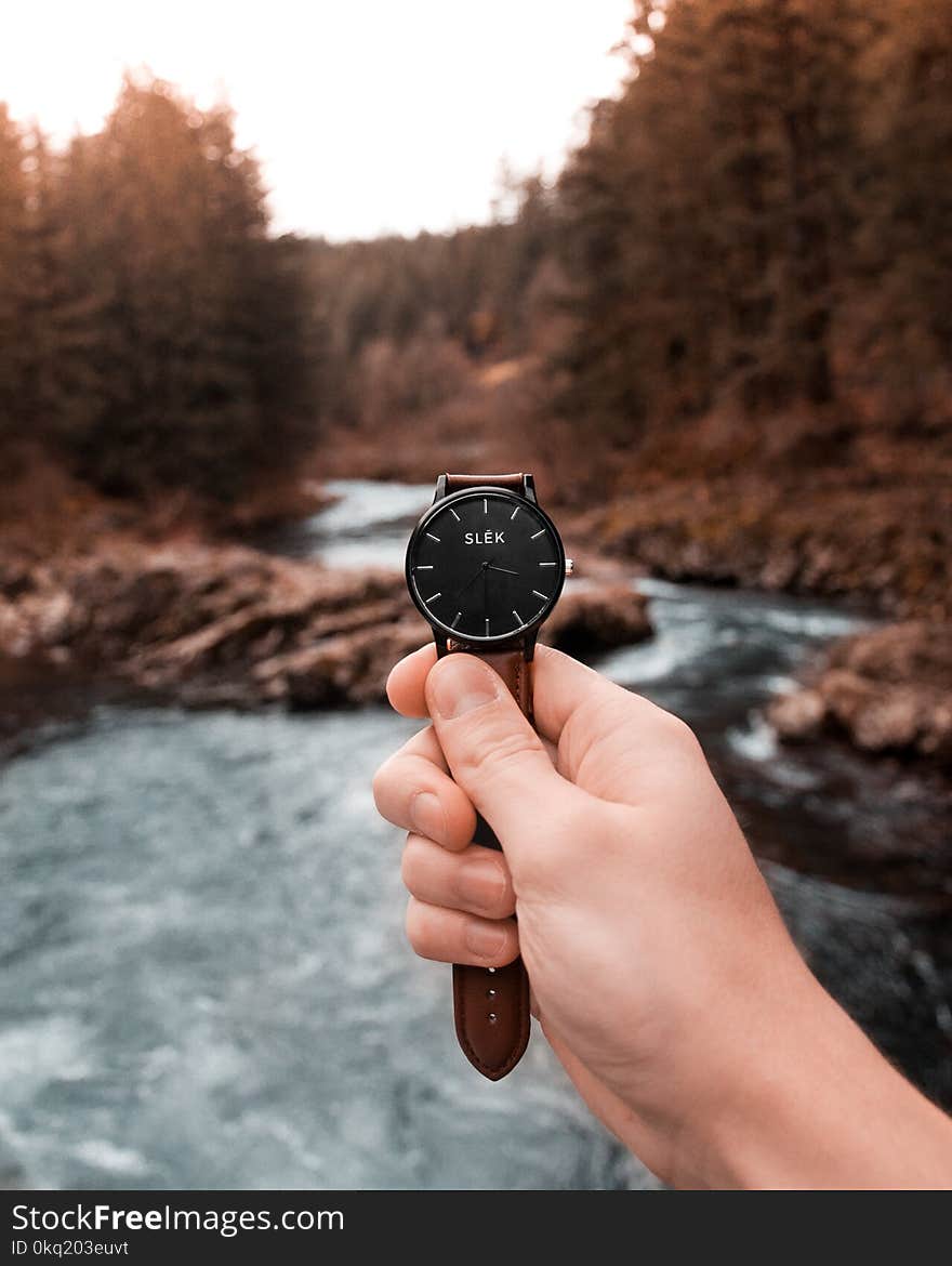 Person Holding Analog Watch Displaying 3:36