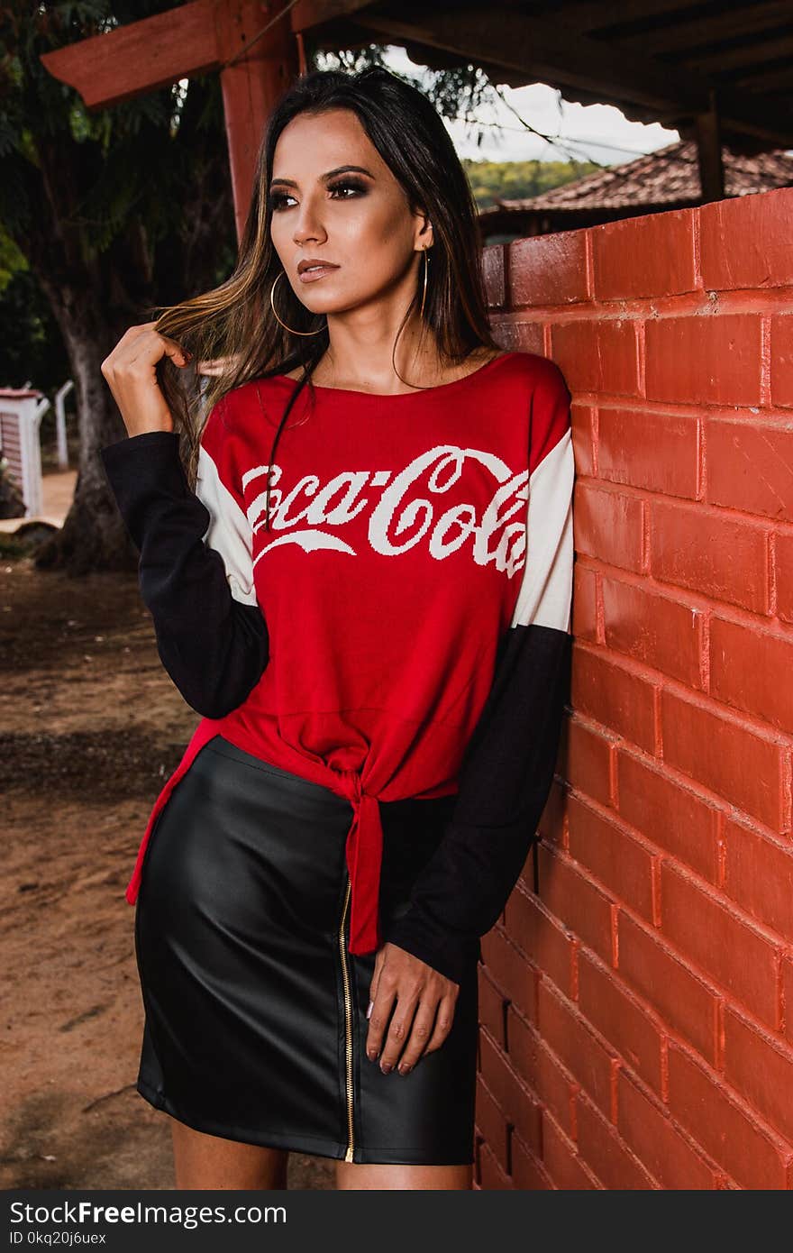 Woman Wearing Black, White, and Red Coca-cola Long-sleeved Shirt and Mini Skirt