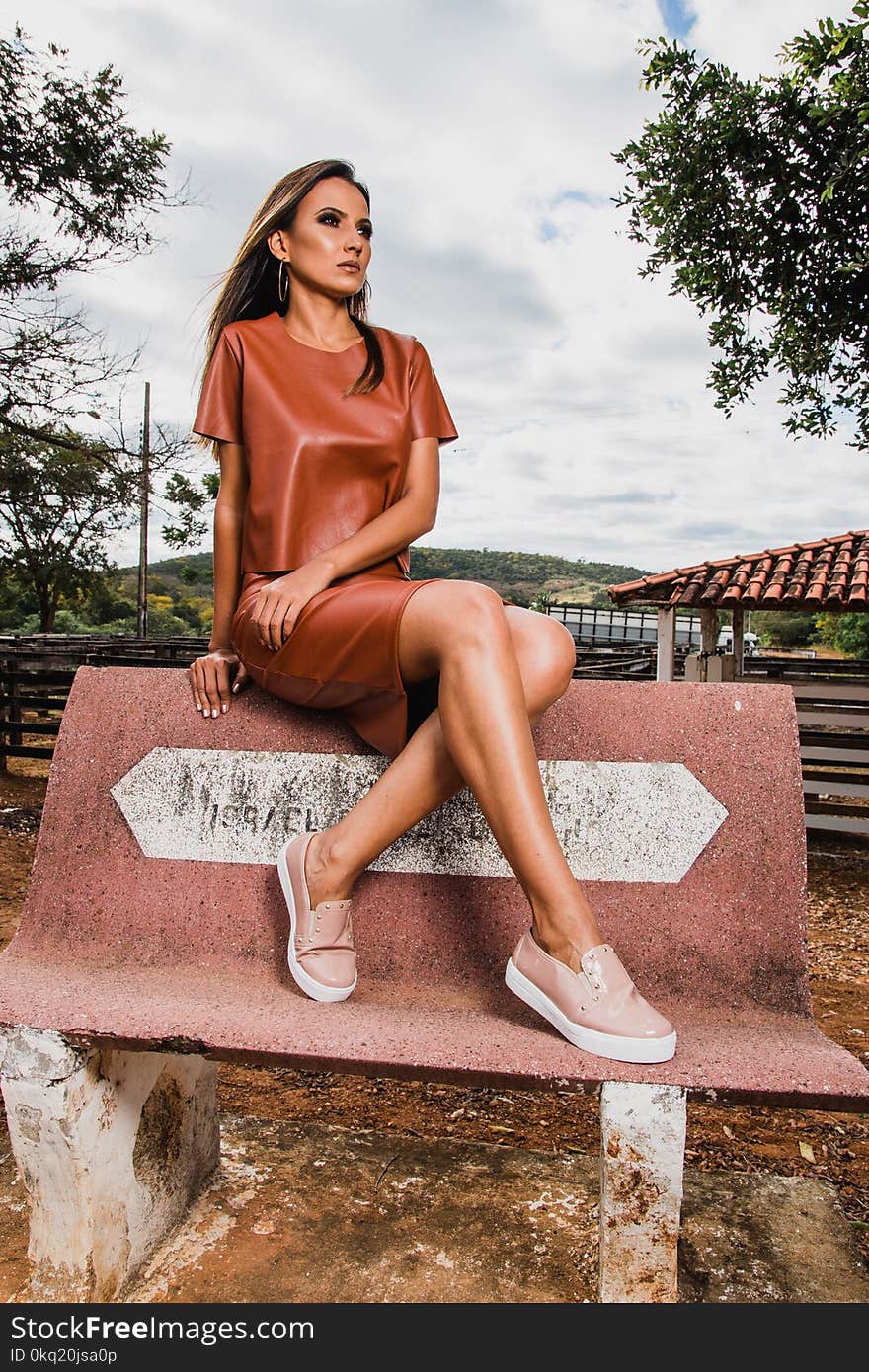 Woman in Brown Leather Skirt and Shirt