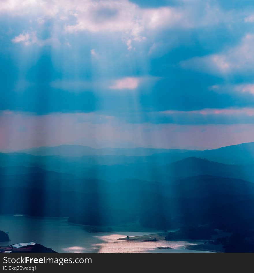 Calm Body of Water Under Sun Rays