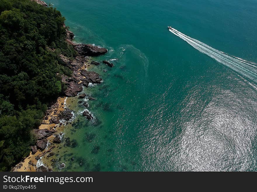 Boat on Body of Water Near Mountain