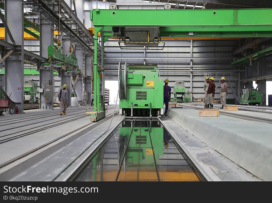 People Stands Near Green Metal Industrial Machine