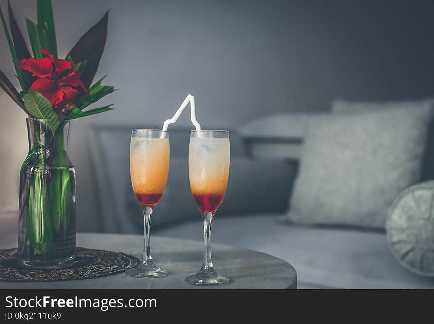 Two Clear Wine Glasses Filled With Red Liquids